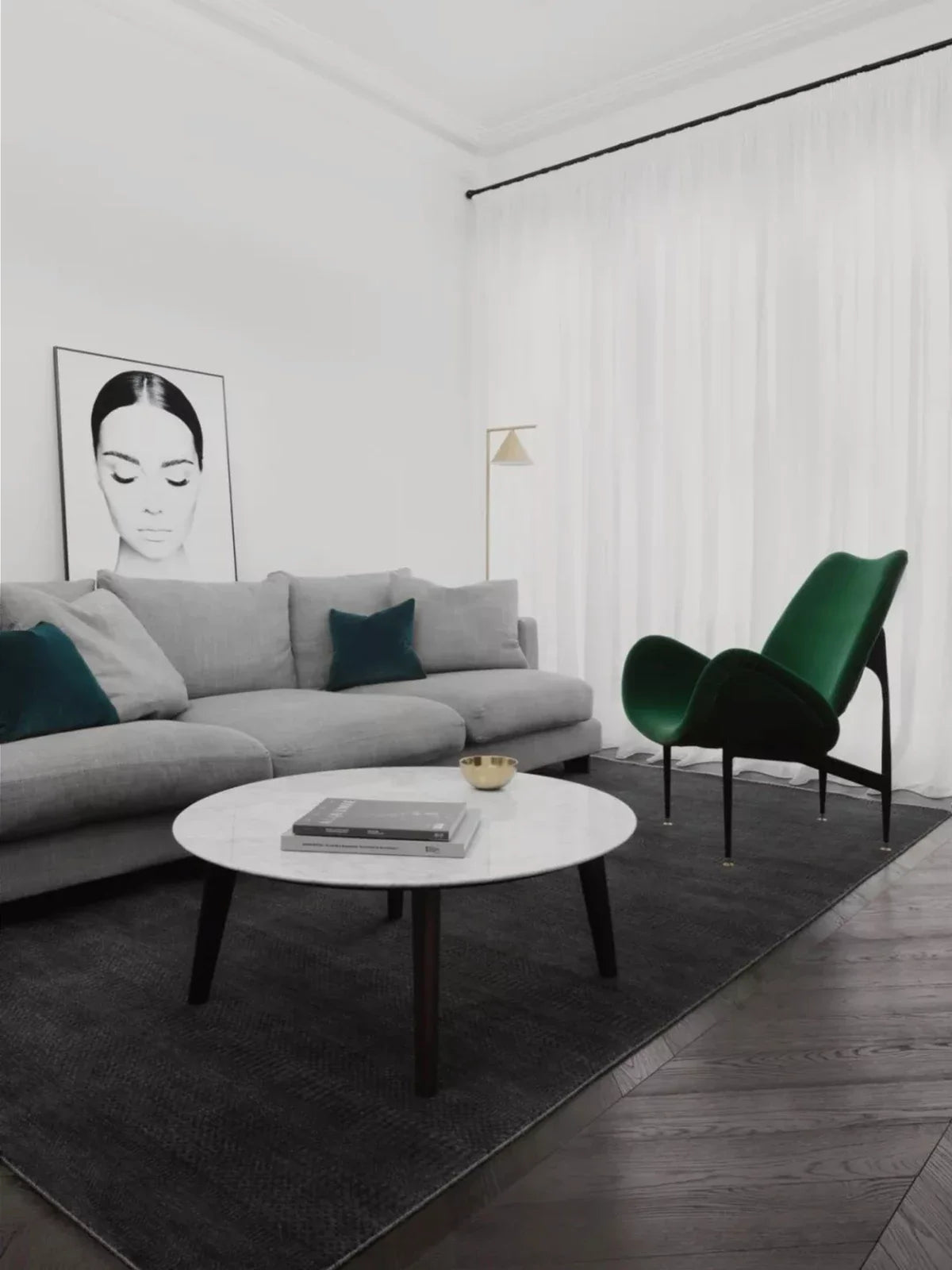 Modern living room featuring a sleek black rug, a minimalist gray sofa, a statement green accent chair, and a marble coffee table for a bold and sophisticated look.