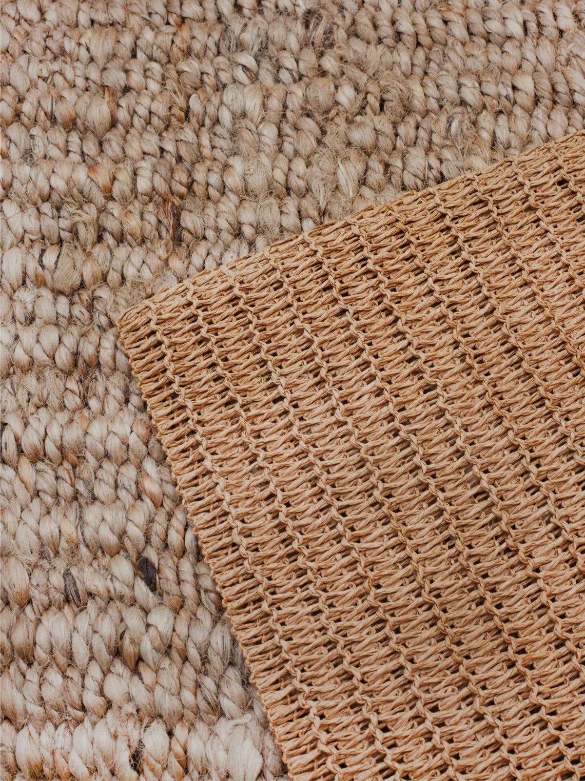 Close-up of a textured jute rug showcasing its natural woven fibers and intricate craftsmanship, adding warmth and organic charm to any space.