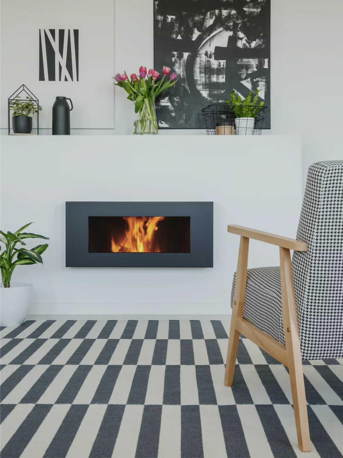 Modern living space featuring a bold black-and-white striped rug, a sleek fireplace, minimalist decor, and a cozy accent chair with a geometric pattern.