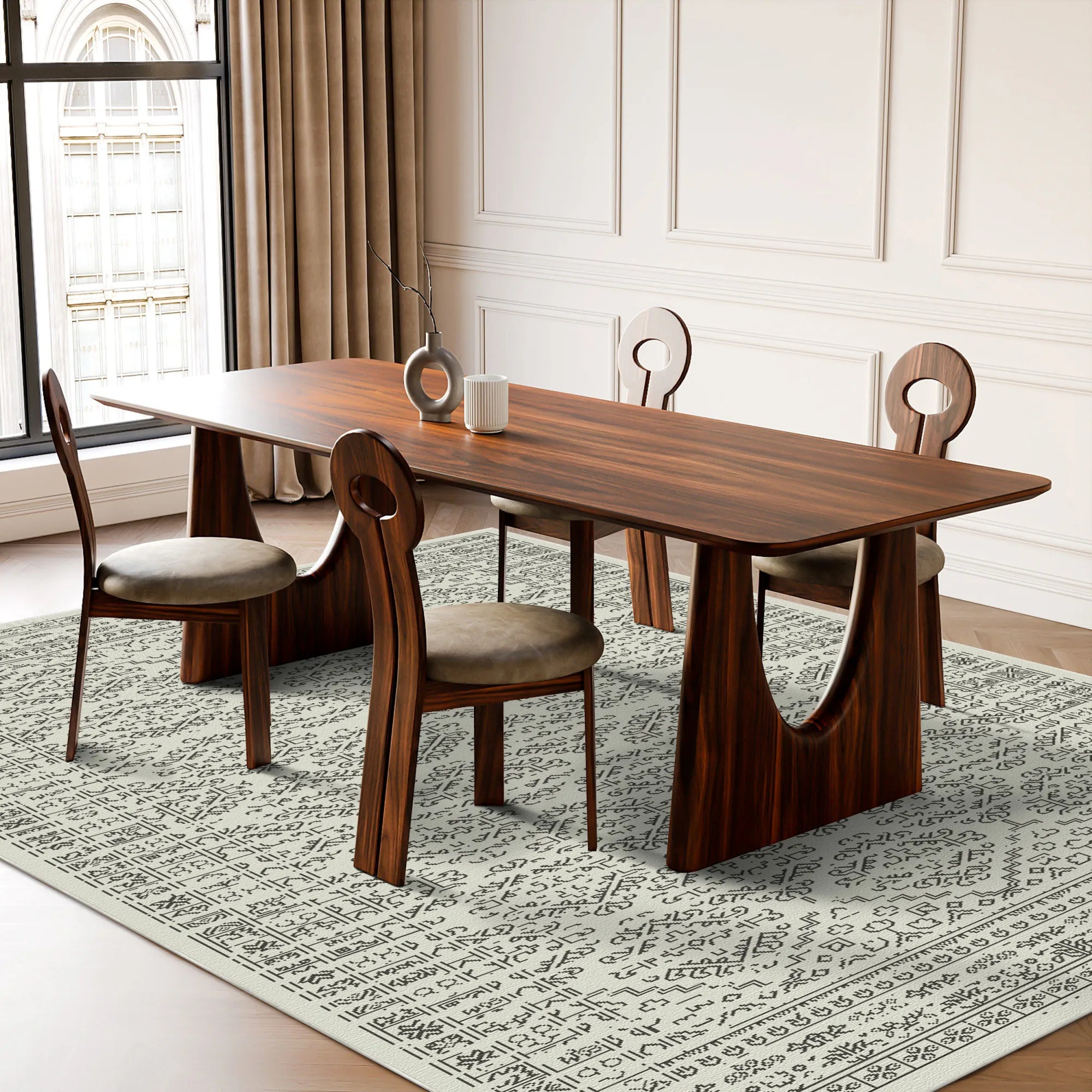 Dining room with a wooden table and chairs on a patterned rug.