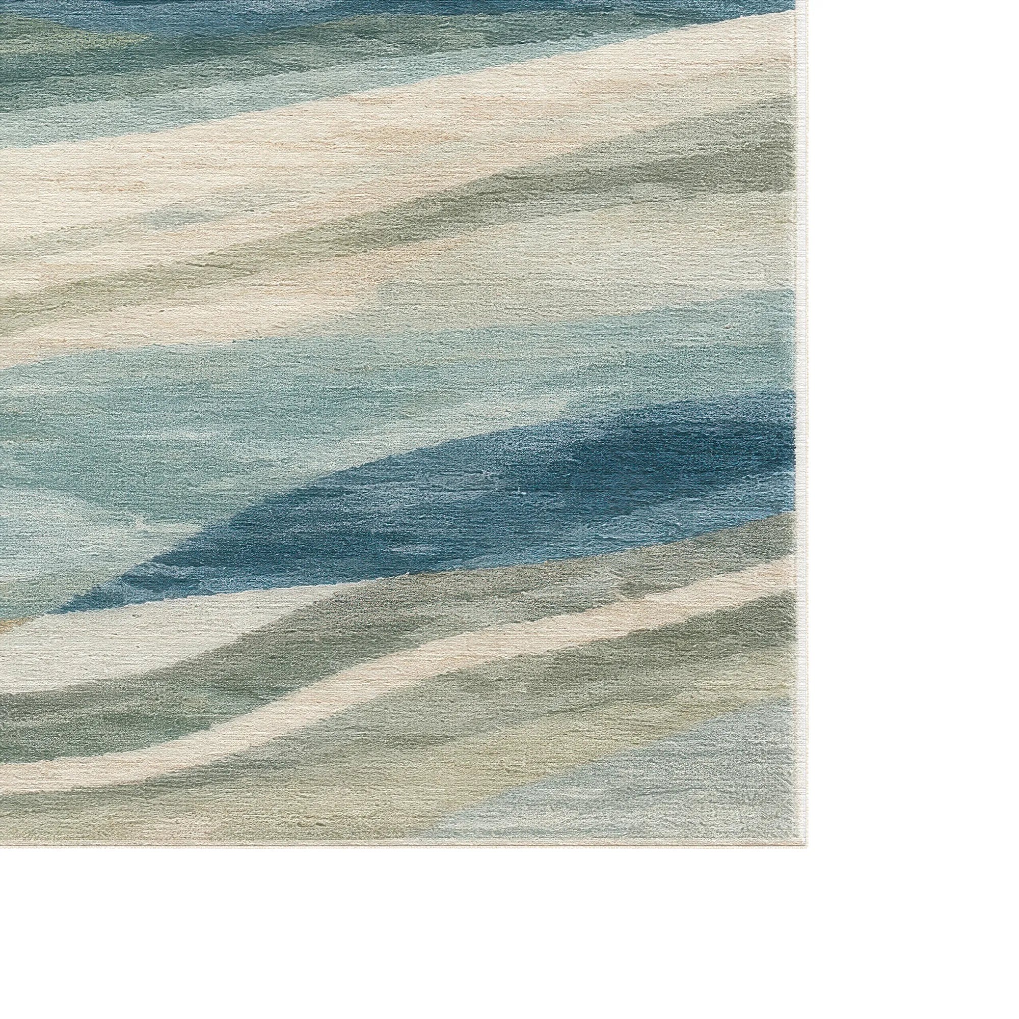 Abstract area rug with a watercolor-like design in shades of blue, beige, and gray, shown cropped to highlight the texture and pattern.